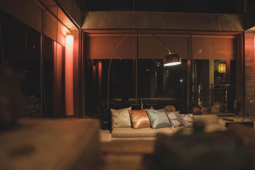 a living room with a couch with pillows on it at 山也未央 宜蘭包棟Villa in Yilan City