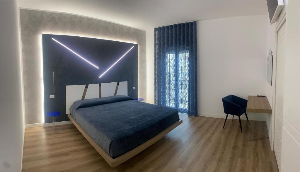 a bedroom with a bed with lights on it at LD Ianuzziello Residence in Scanzano
