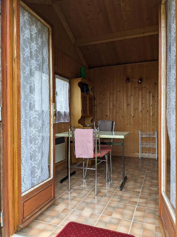 a room with a table and chairs in a house at Au petit chalet d&#39;Illiers Combray in Illiers