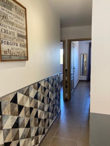 a hallway with a checkered tile on a wall at Appartement Cemiliana in Bonifacio