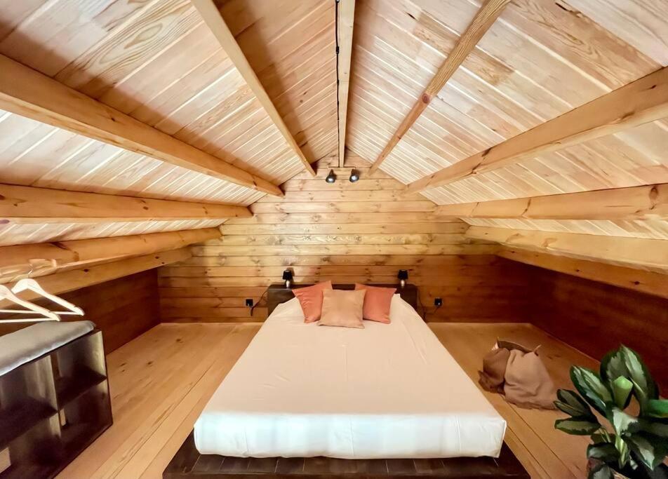 a large room with a bed in a wooden room at Mountain Eco Shelter 8 in Funchal