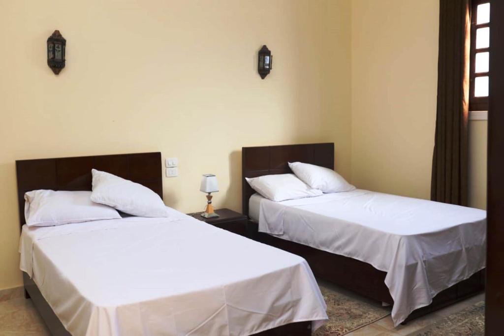 Postel nebo postele na pokoji v ubytování Happiness Guest House