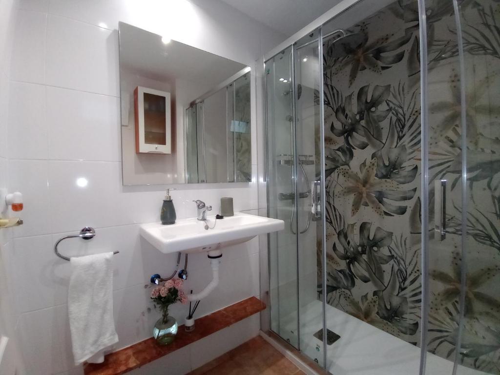 a bathroom with a sink and a shower at Ático, Islantilla in Islantilla
