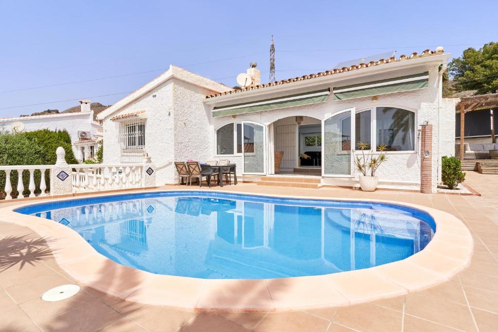 a swimming pool in front of a house at Casa Ambar in Nerja