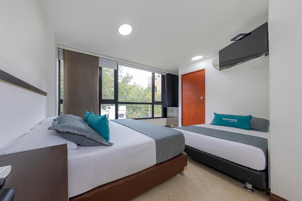 Postel nebo postele na pokoji v ubytování Hotel Ayenda Palo Alto