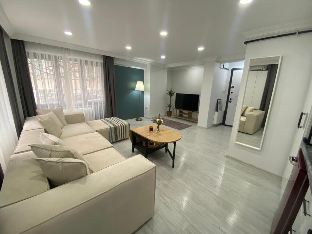 a living room with a white couch and a table at Sisli Central Apartments in Istanbul