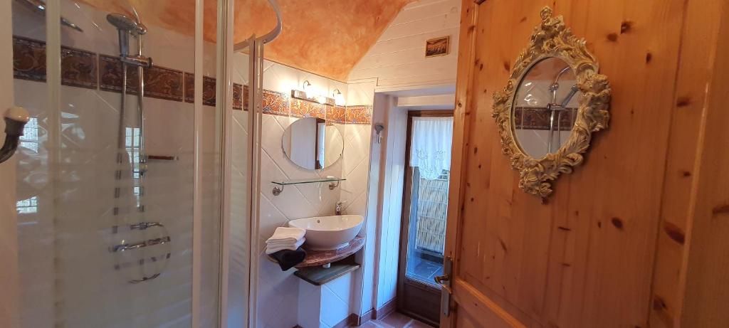 a bathroom with a sink and a mirror on the wall at Le Castellou in Conques