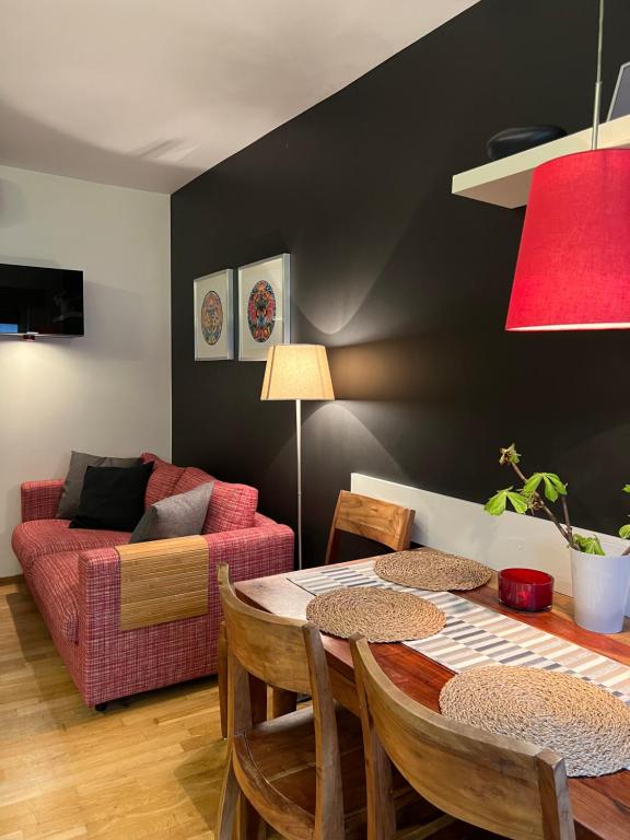 - un salon avec une table et un canapé rouge dans l'établissement Apartament Baryłka, à Kazimierz Dolny