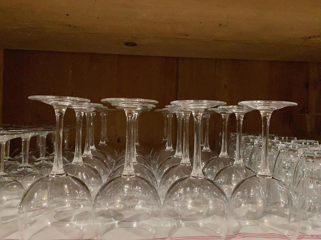 a row of wine glasses sitting on a table at Moulin de la Rouchotte in Frétigney-et-Velloreille