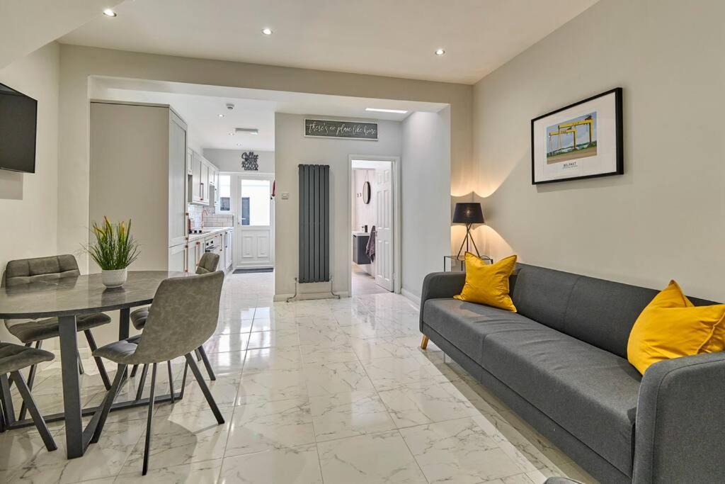 a living room with a couch and a table at Belfast Luxury Lets - Windsor Townhouse in Belfast