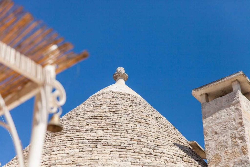 a brick chimney on top of a building at La corte di Ercole in Alberobello