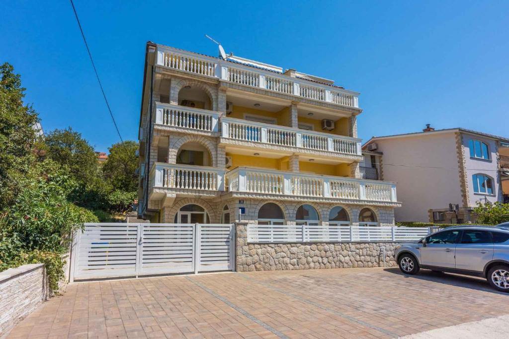 a building with a car parked in front of it at Studio Apartment in Crikvenica XIV in Crikvenica
