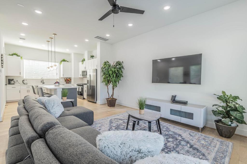 a living room with a couch and a kitchen at Your home away from home in Houston