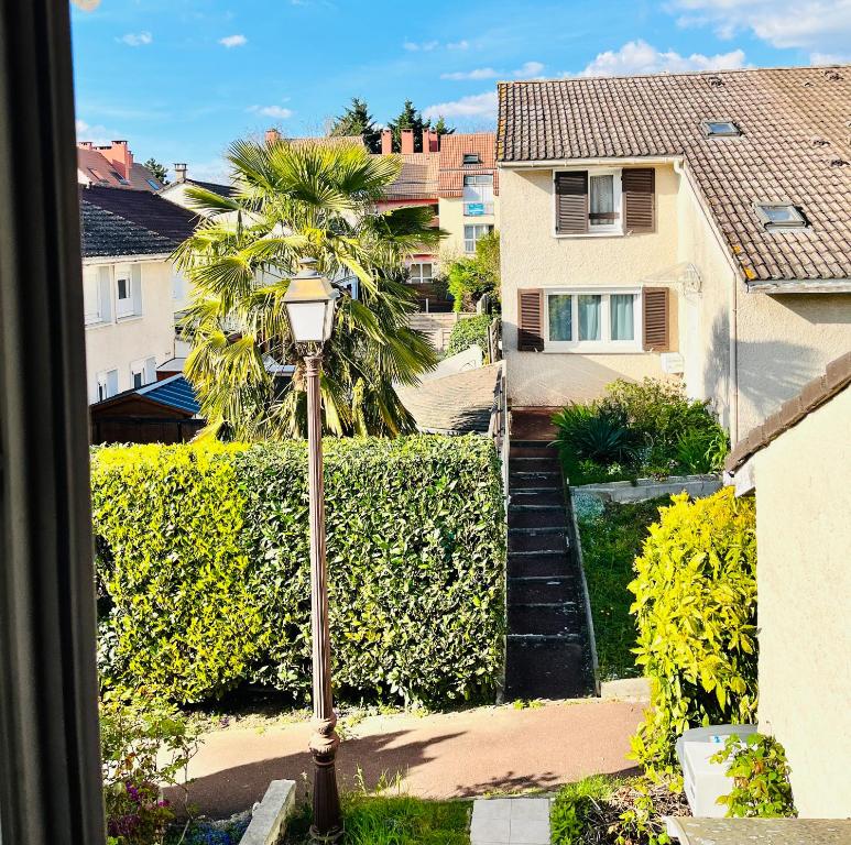 a view from a window of a house with a street light at Private rooms in a Tiny home 4 min drive to Airport CDG ,1 private bathroom ideal for families and friends in Roissy-en-France