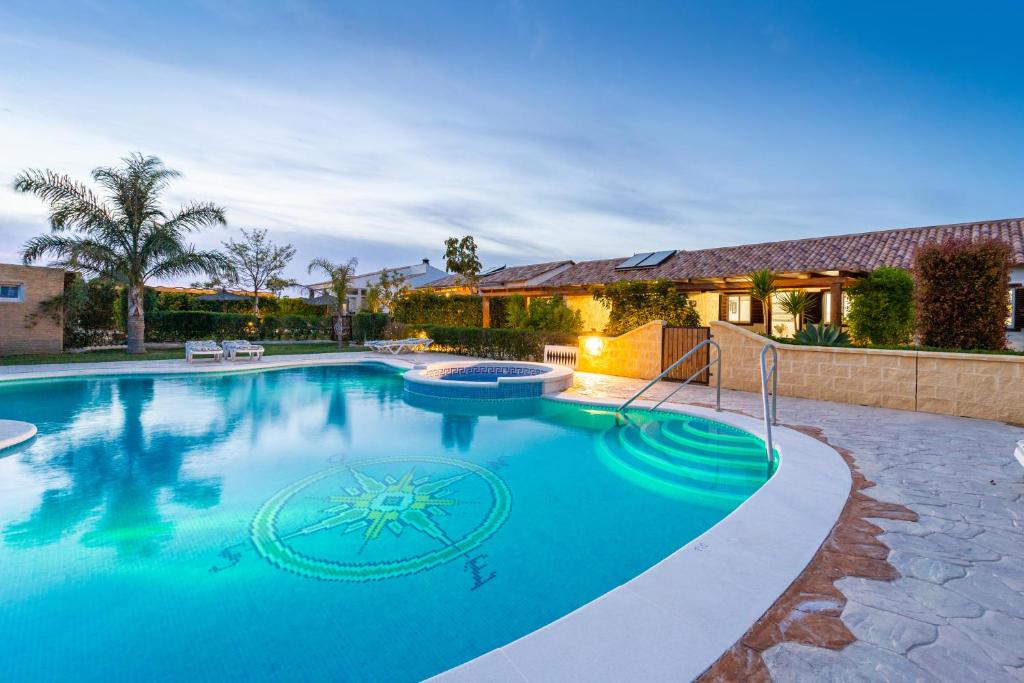 a large swimming pool in a yard with a house at Apartamento Jibazahora Escorpio in Zahora