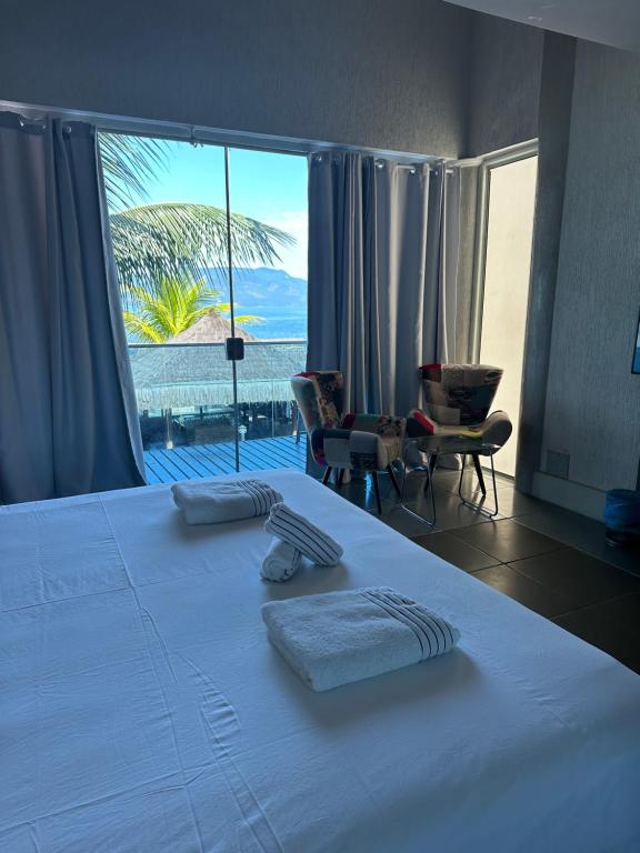 Кровать или кровати в номере Residência Angra Deep Blue