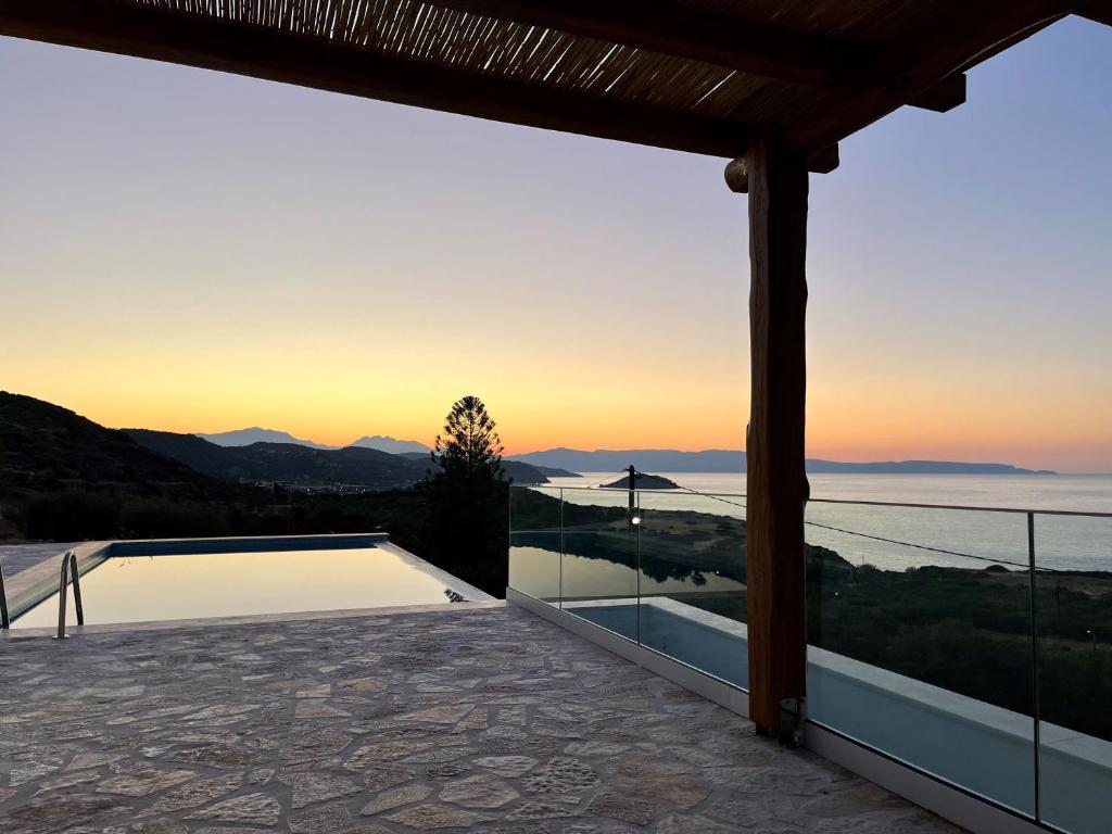 a view of the sunset from the deck of a house at Villa Thea in Mochlos