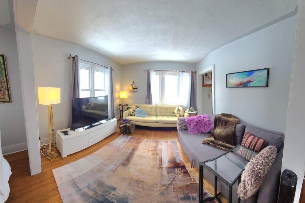 a living room with a couch and a flat screen tv at The Sailing Gypsy and Bunkie incl in pricing June 22-Sept 14 in Port Elgin