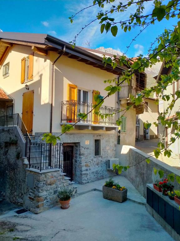a house with a staircase in front of it at Cozy Home Maison Cascina Amélie in Abbadia Lariana