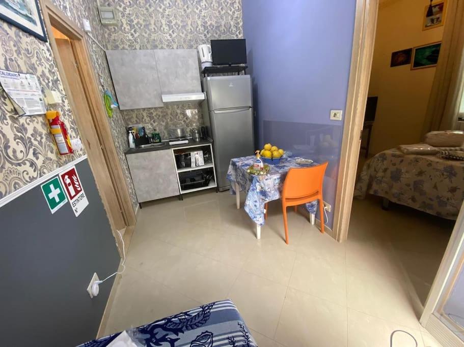 eine kleine Küche mit einem Tisch und einem Kühlschrank in der Unterkunft Popi al mare in villa con giardino e wifi in Sestri Levante
