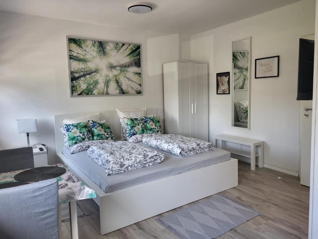 a bedroom with a bed with two pillows at A Comfortable and Modern Newly Renovated Apartment in Mannheim