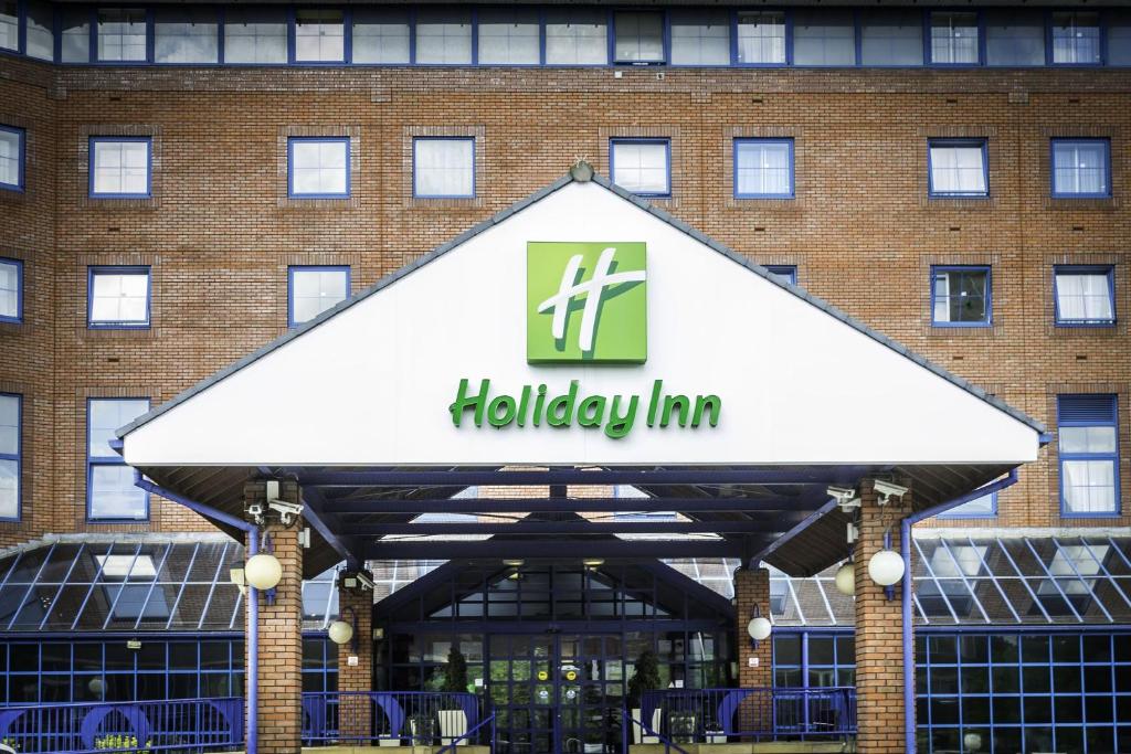 a sign for a holiday inn in front of a building at Holiday Inn London Sutton, an IHG Hotel in Sutton
