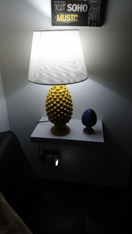 a lamp sitting on a table next to a wall at Alba central City in Palermo