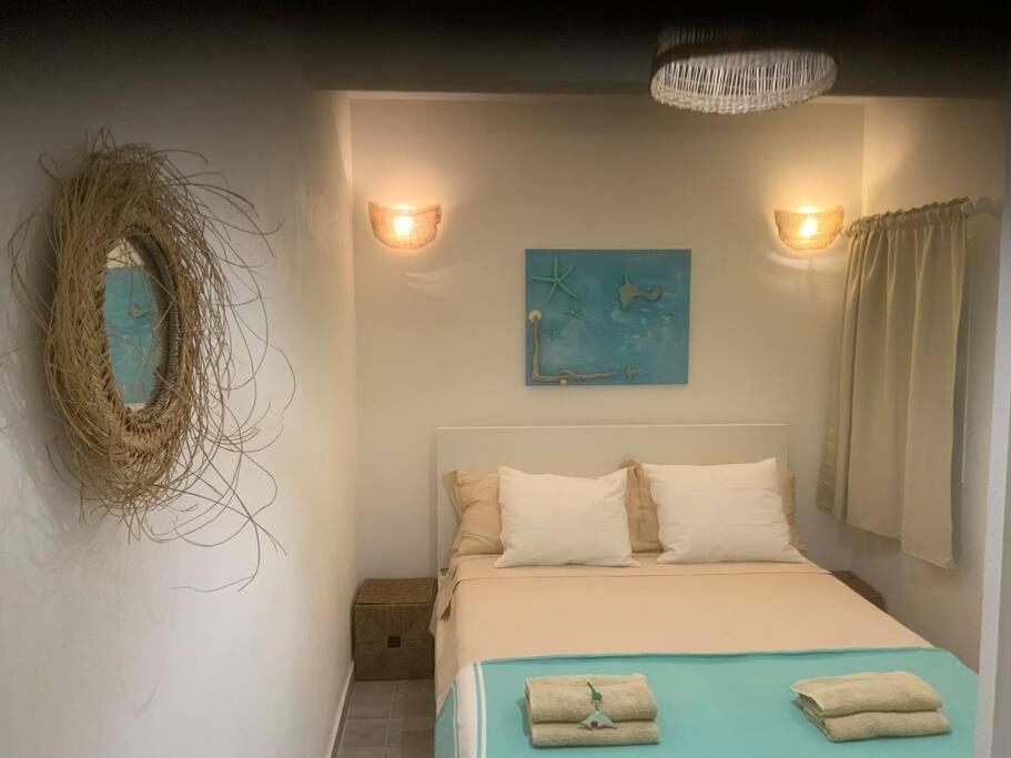 a bedroom with a bed and a mirror at Es Pujols isla de la Calma in Es Pujols