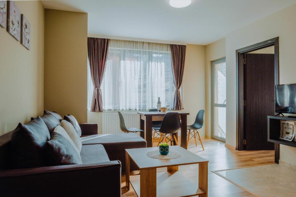 a living room with a couch and a table at Katerina Apartments 2 in Velingrad
