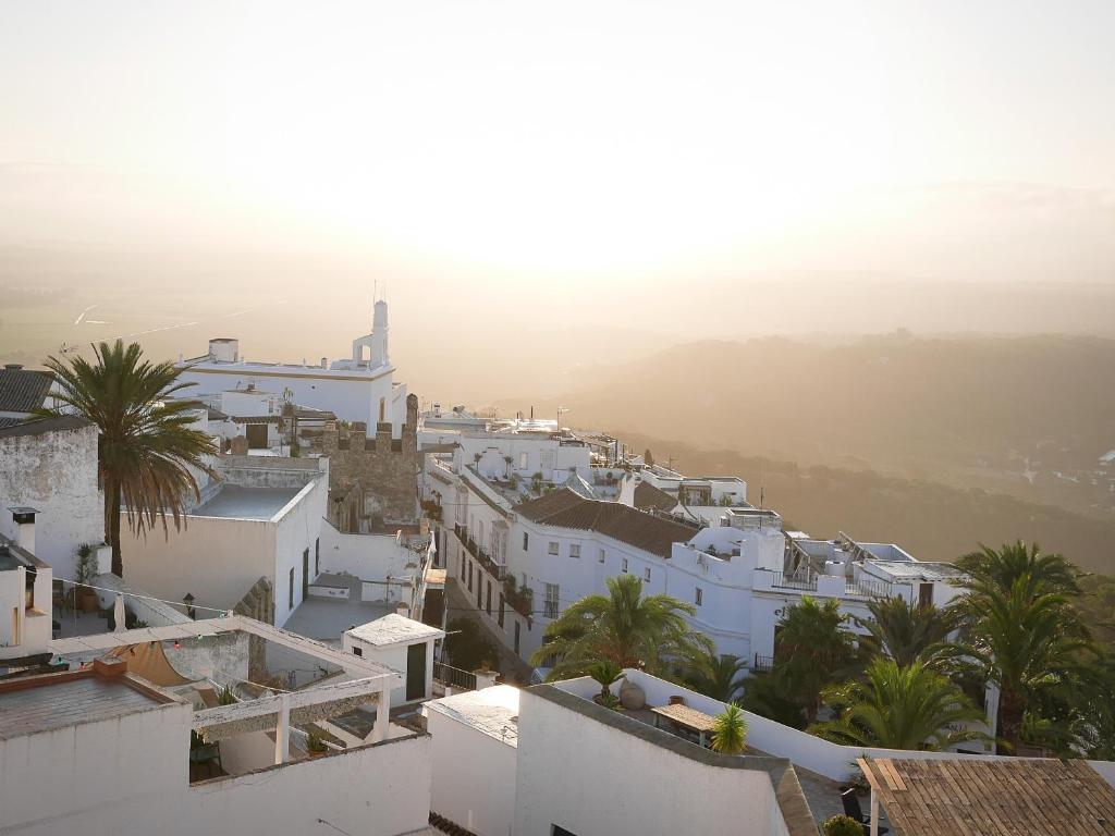 a view of a town with white buildings and a church at La Pileta in Vejer de la Frontera