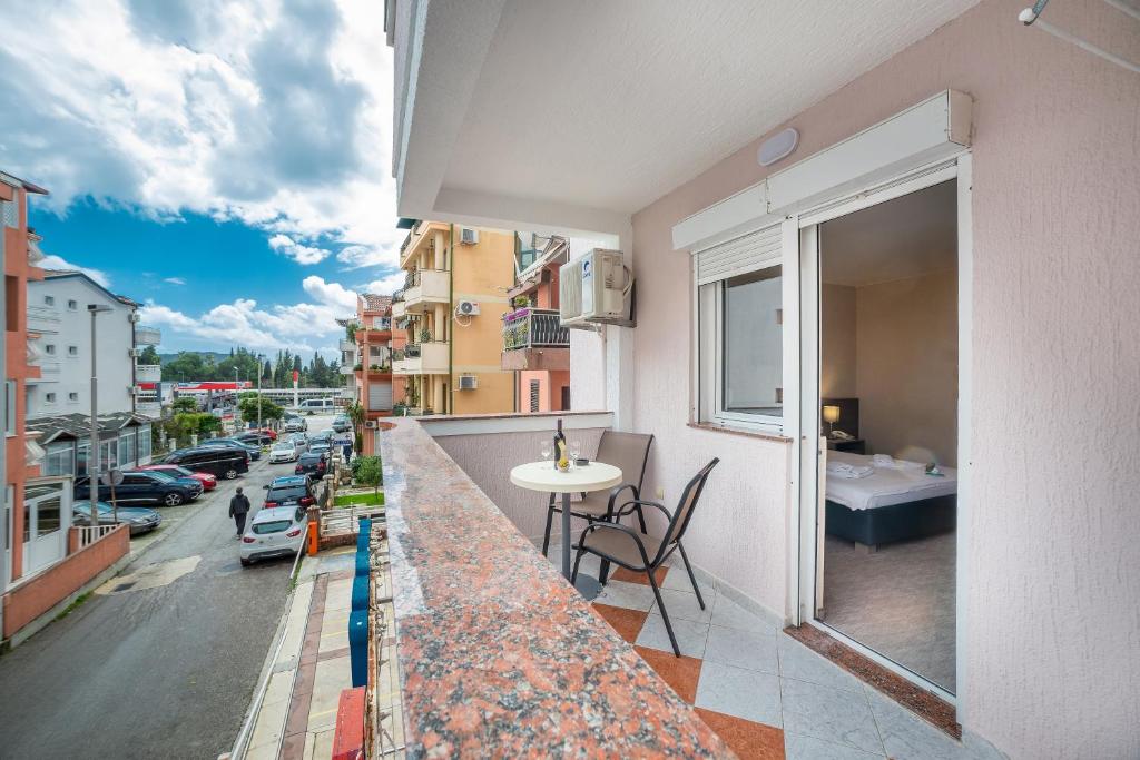 a balcony with a table and a view of a street at Garni Hotel MB in Budva