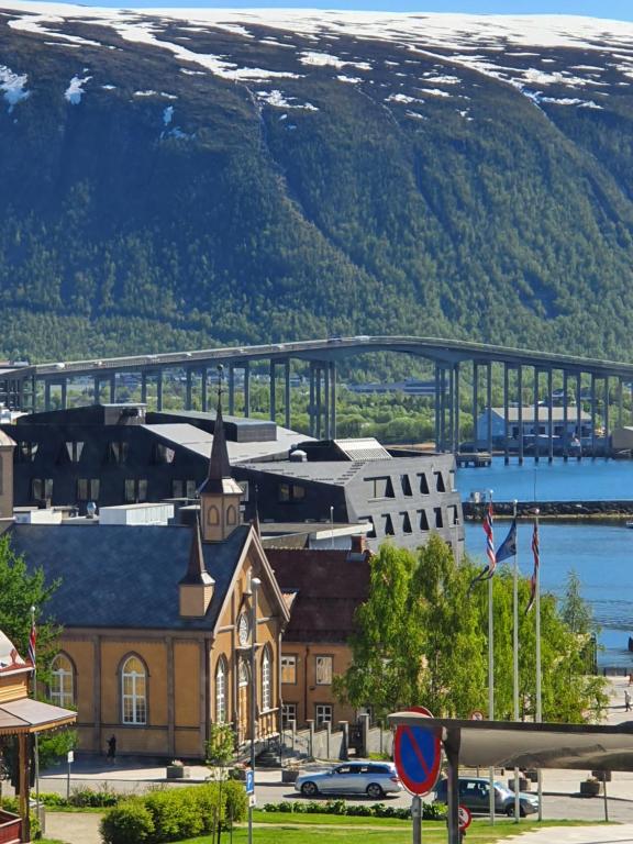 a bridge over a city with a town and a building at Small and cute apartment in city center in Tromsø