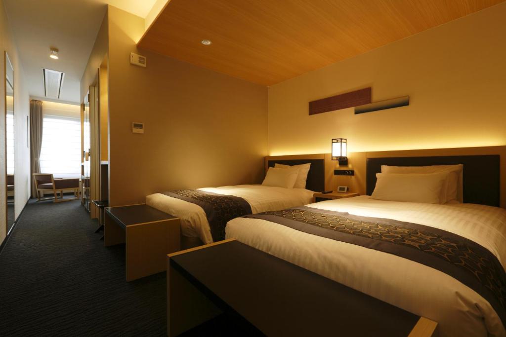 Cama ou camas em um quarto em Kanazawa Sainoniwa Hotel