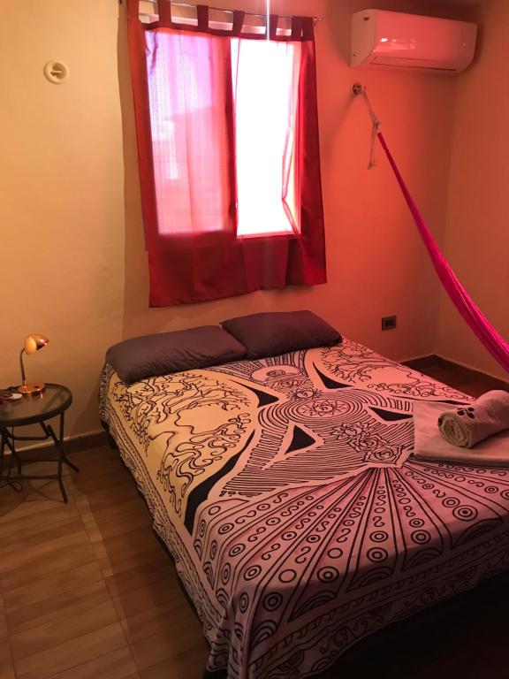 a bed in a room with a window at Venado 28 in Cancún
