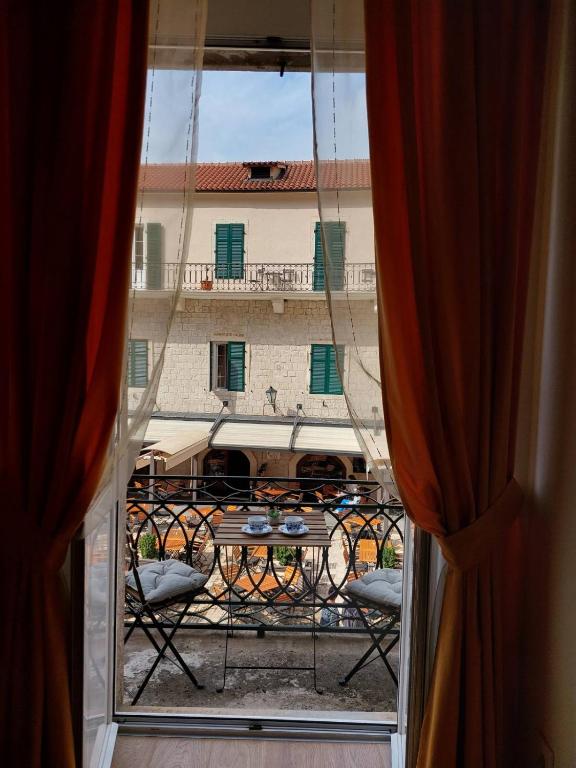 an open window with a view of a building at Main Square View in Kotor