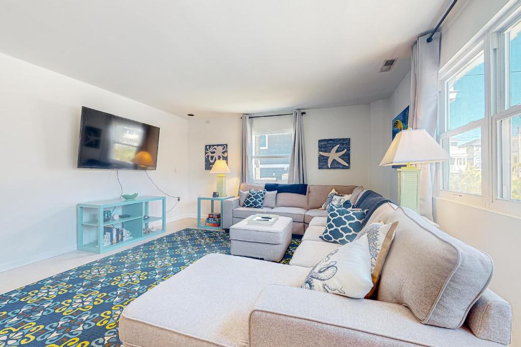 a living room with a couch and a tv at Town of South Bethany --- 5 Surfside St in Bethany Beach