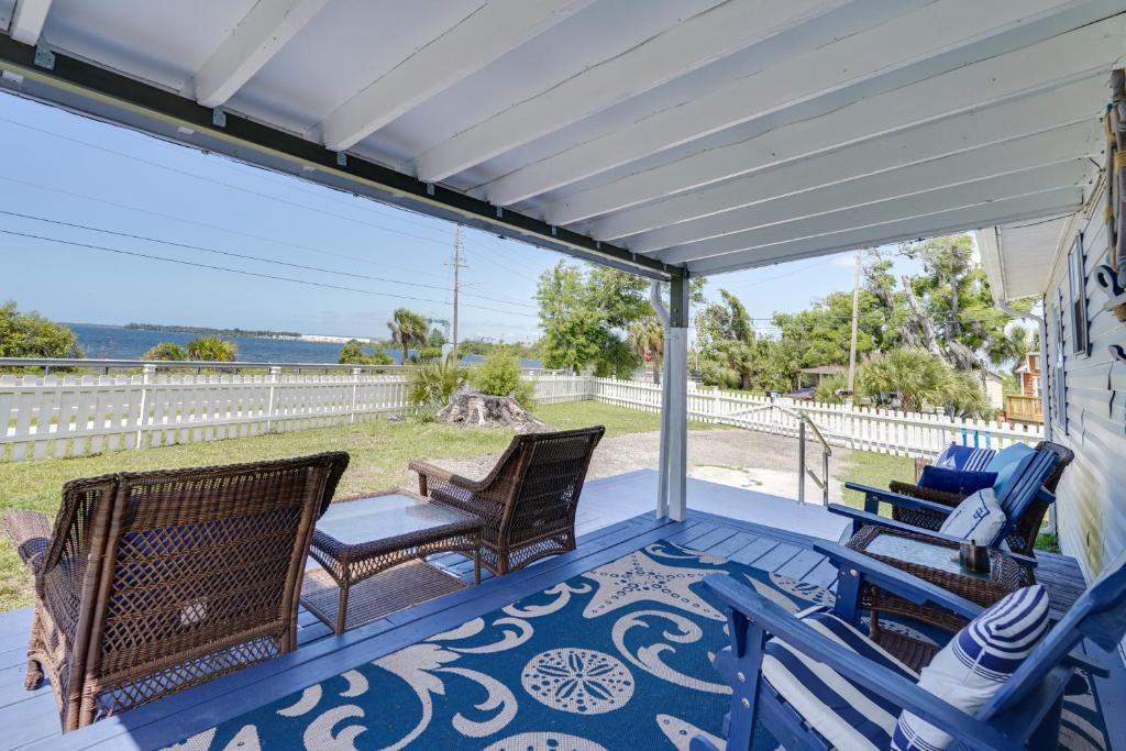 a porch with rocking chairs and awning at Cottage with St Andrews Bay Views, Deck and Porch! in Panama City