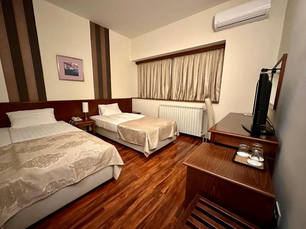 Postel nebo postele na pokoji v ubytování Hotel Centar