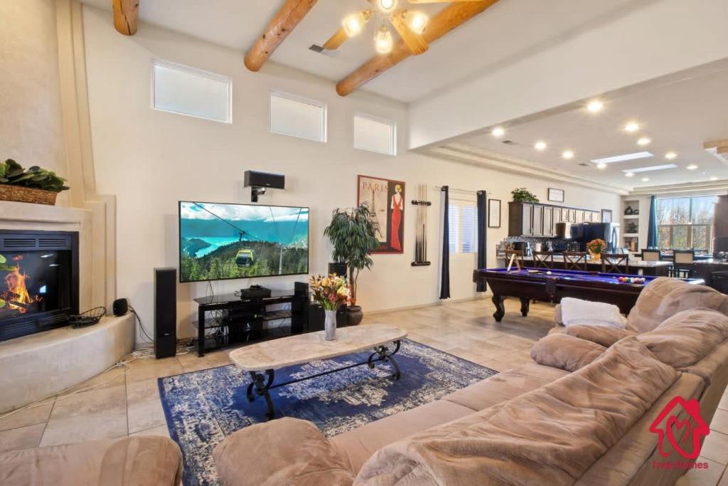 a living room with a couch and a pool table at Desert Hills - An Irvie Home in Albuquerque