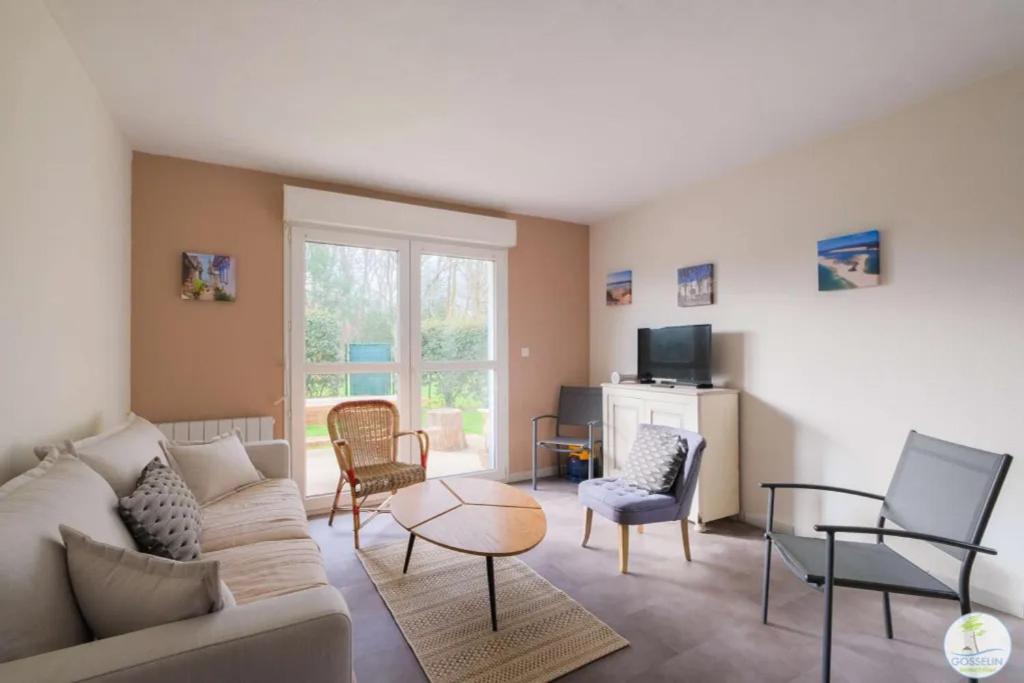 un salon avec un canapé, des chaises et une table dans l'établissement Appartement Biscarrosse joli T3 avec terrasse et jardin privatif classé 1 étoile, à Biscarrosse