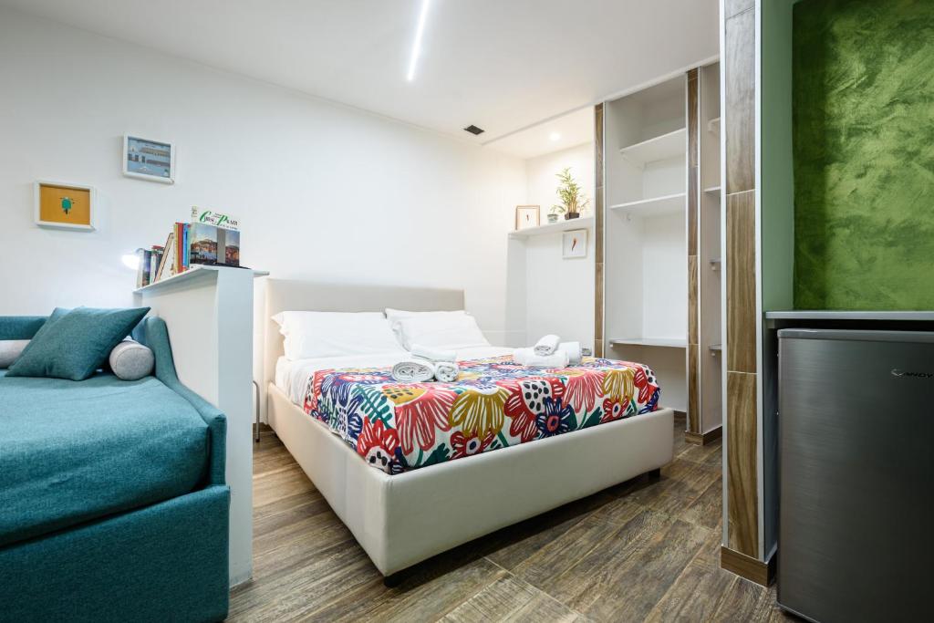 a bedroom with a bed and a couch at Loft by B&B Università in Naples