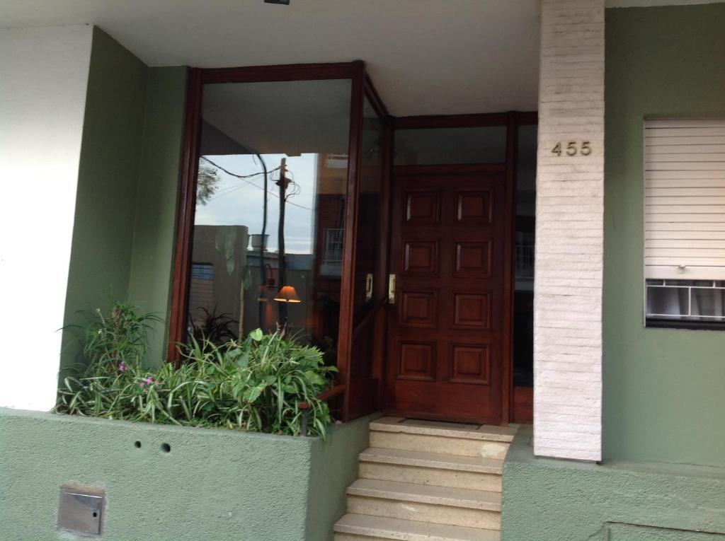 una puerta delantera de una casa con escaleras y plantas en Departamento Olivos-zona puerto en Olivos