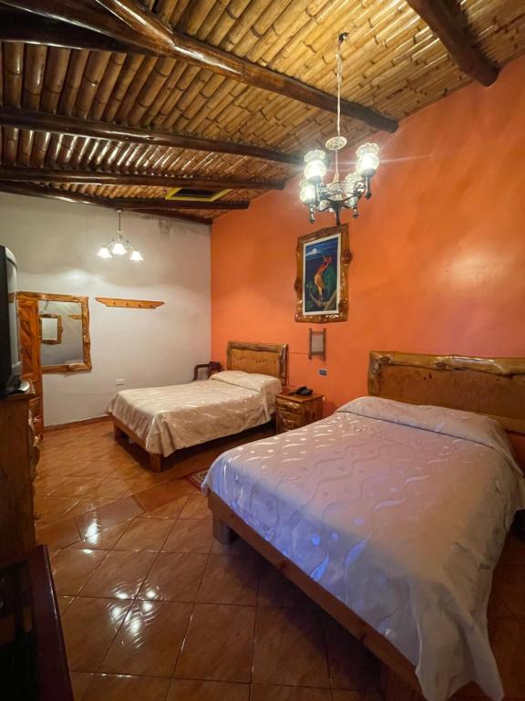 Postel nebo postele na pokoji v ubytování HOTEL El INDIO