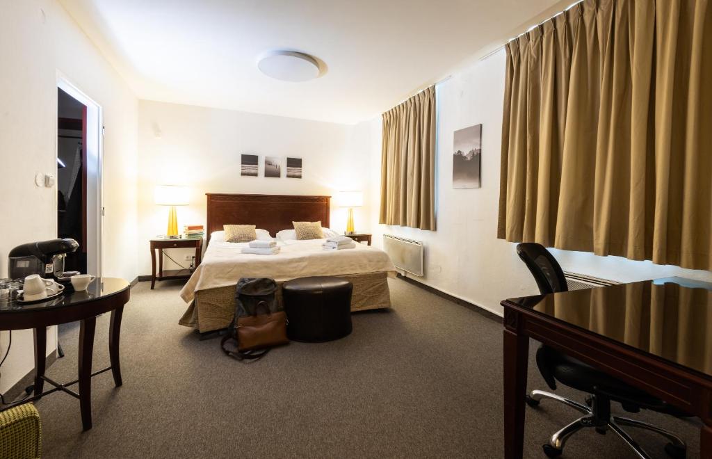 Postel nebo postele na pokoji v ubytování Hotel Petrovy kameny