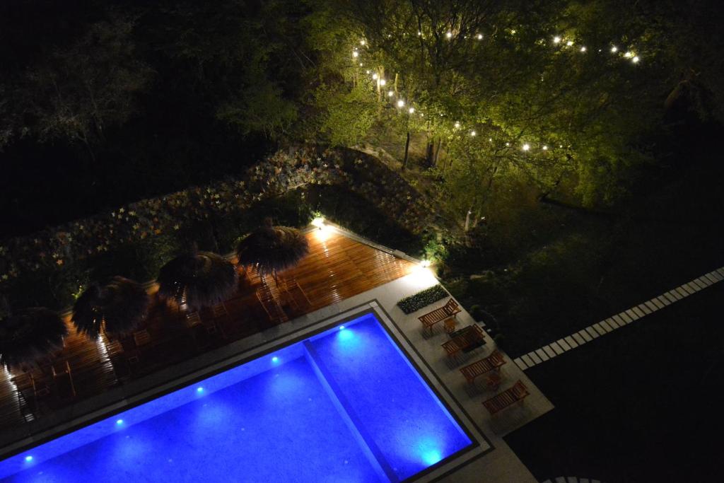 an overhead view of a swimming pool at night at Olivia's Hill Resort in Durrës