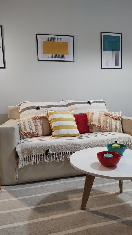 a living room with a couch with pillows and a table at Recoleta 2 amb in Buenos Aires