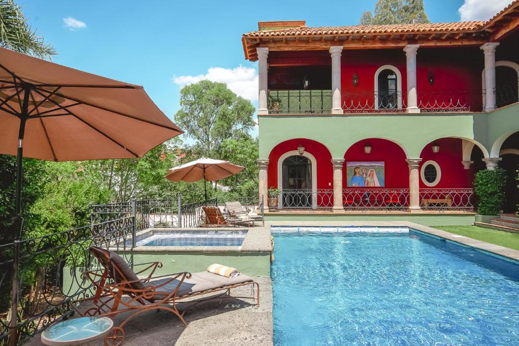 a house with a swimming pool in front of a house at Casa Don Pascual Hotel Boutique Sweet Home in San Miguel de Allende