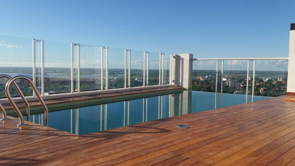 a balcony with a swimming pool on top of a building at Miradores del Chaco in Asuncion
