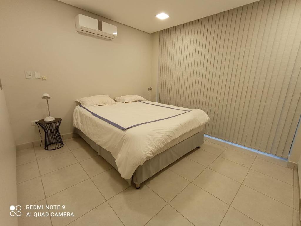 a bedroom with a bed in a room at Miradores del Chaco in Asuncion