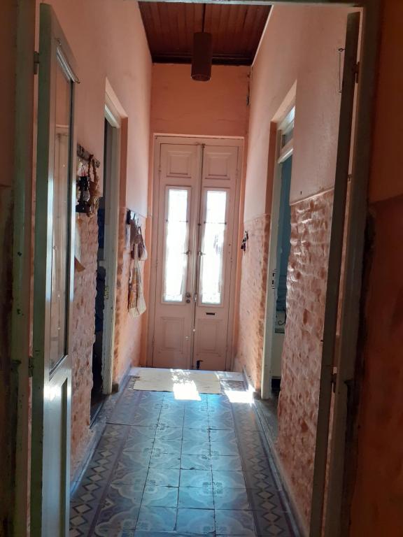 a hallway of a house with a door and a tile floor at INFINITO YO, espacio pensado para mujeres solas o con su pareja in Carmelo